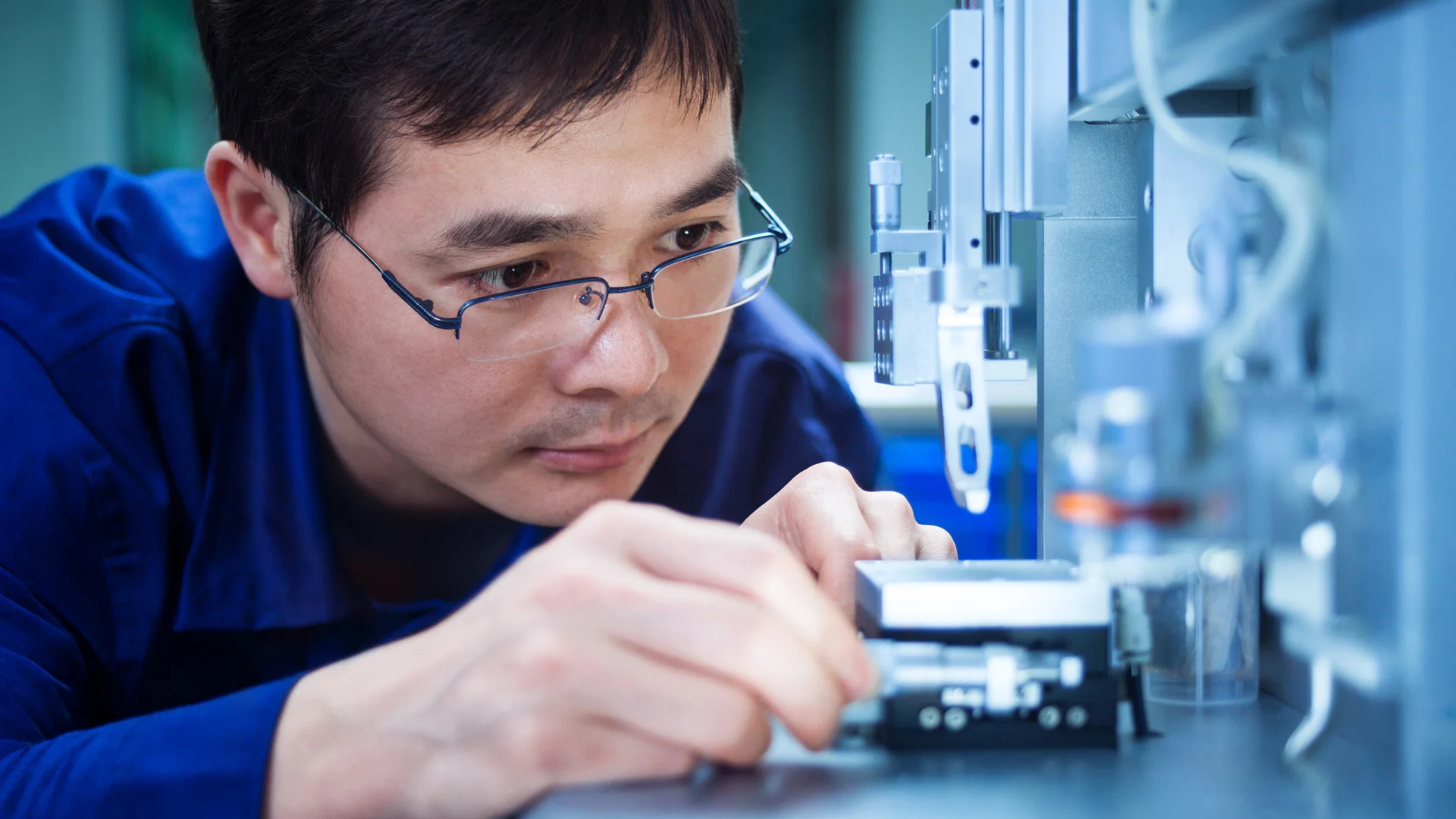 Man in glasses working with machinery