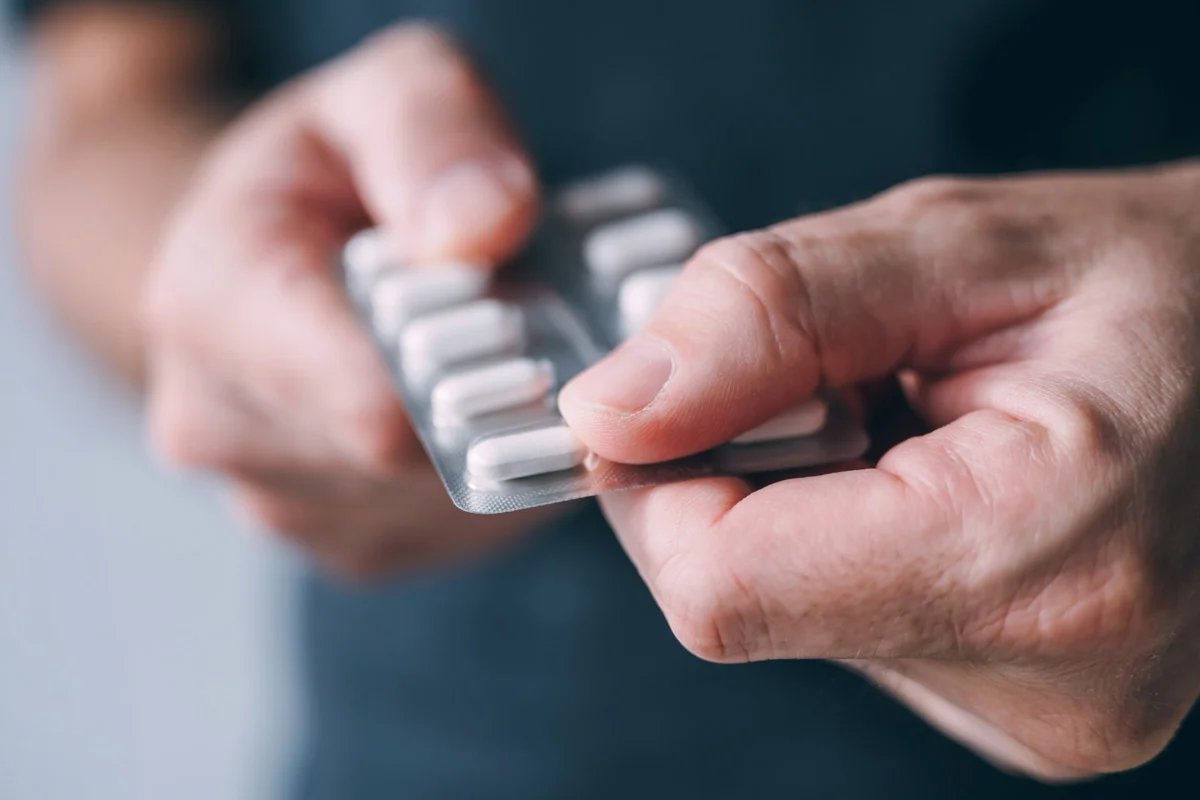 Hands holding onto a blisterpack of pills