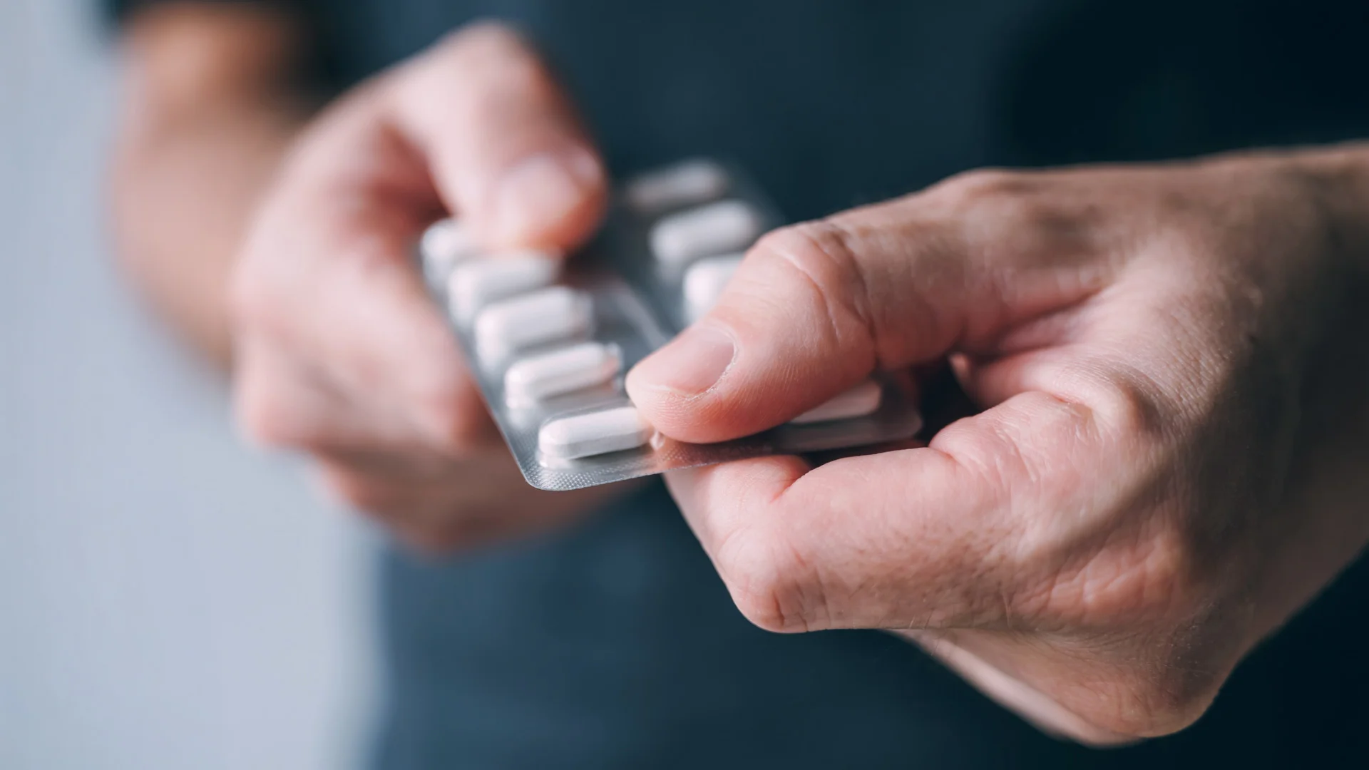 Hands holding onto a blisterpack of pills
