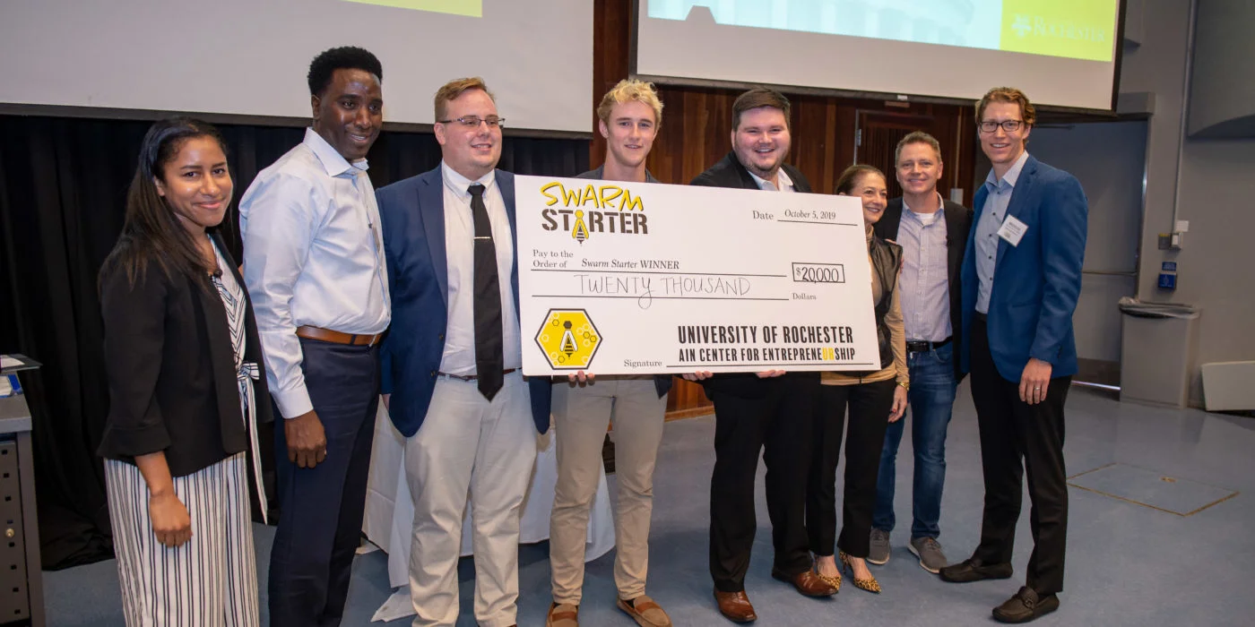 Image of team holding a large cheque