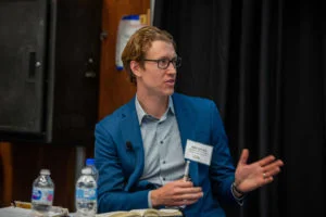 Image of man in glasses talking